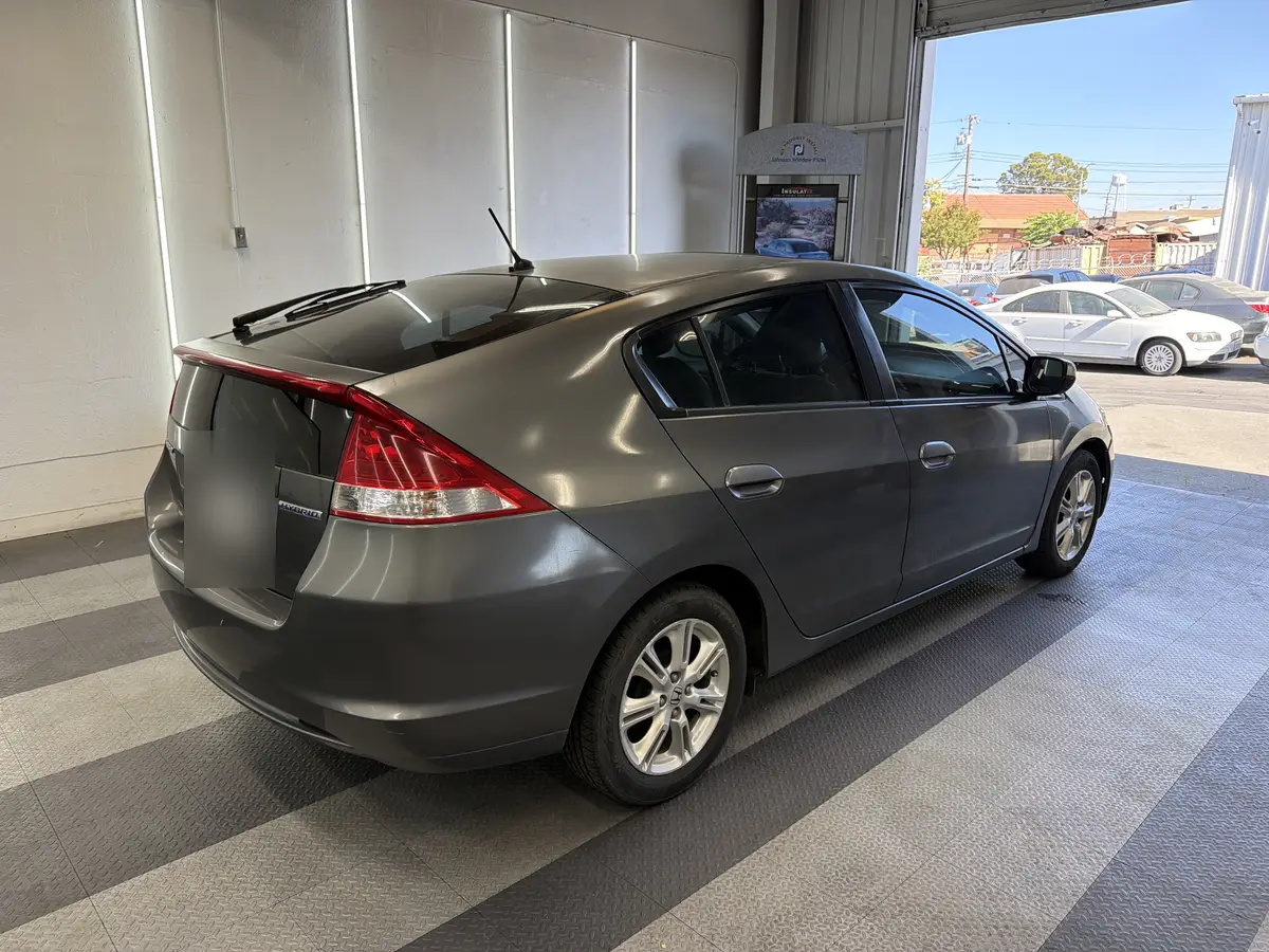 Gray Honda Insight before window tinting, factory glass (view 3)