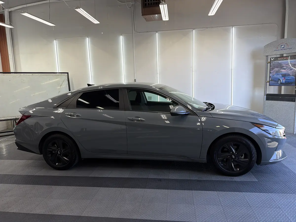 Gray Hyundai Elantra before window tinting, factory glass (view 1)