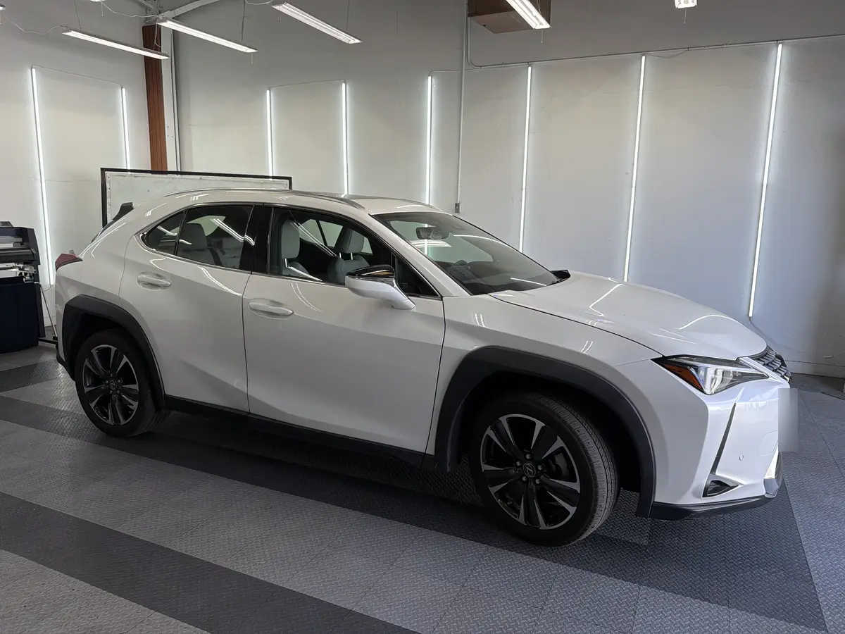 White Lexus UX before window tinting, factory glass (view 1)