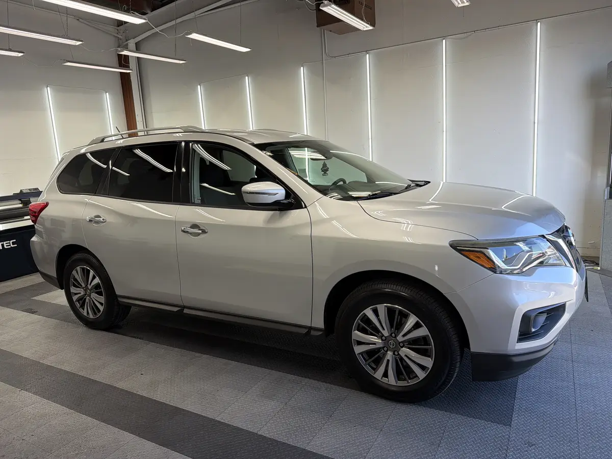 Silver Nissan Pathfinder before window tinting, factory glass (view 1)
