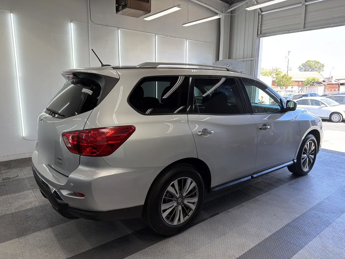 Silver Nissan Pathfinder before window tinting, factory glass (view 2)