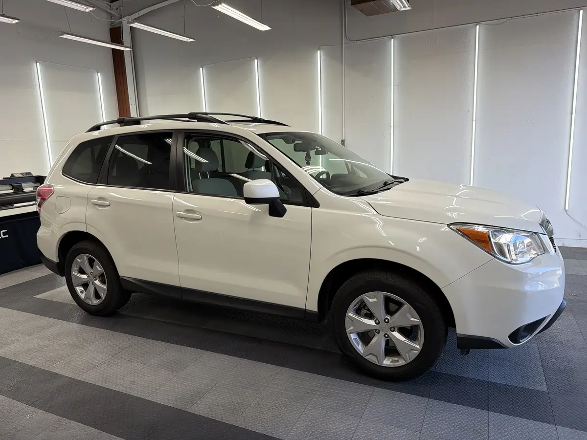 White Subaru Forester before window tinting, factory glass (view 1)