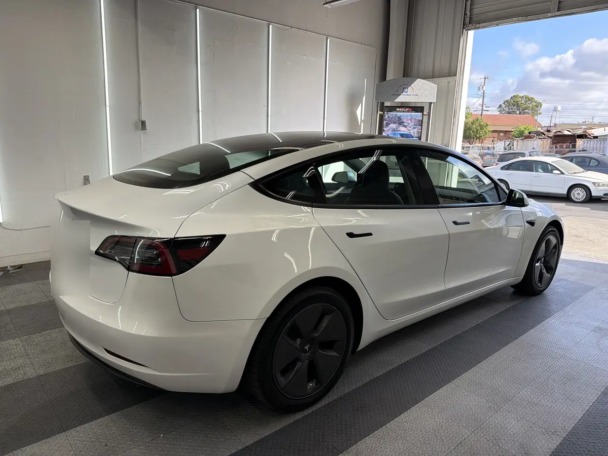 White Tesla Model 3 before window tinting, factory glass (view 3)