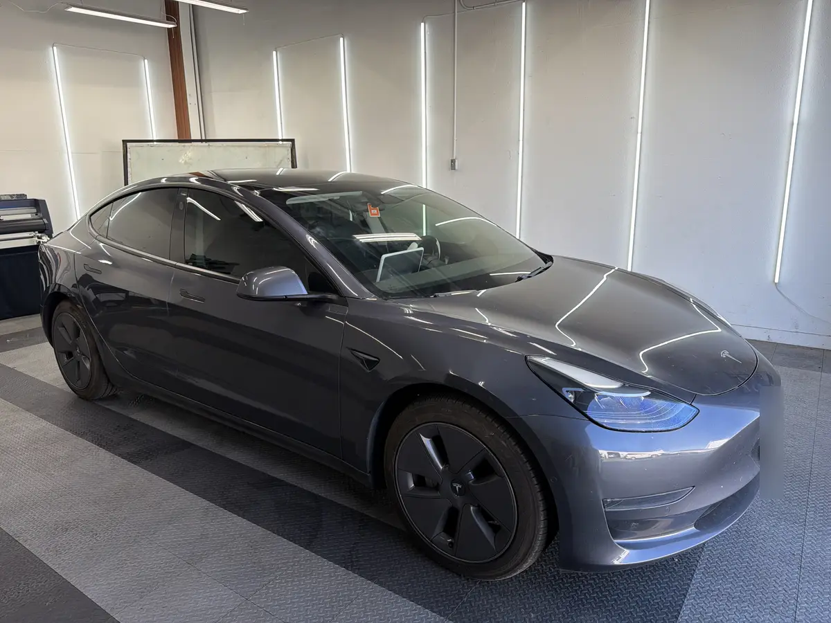 Gray Tesla Model 3 at Quality Window Tinting, ceramic window tint job (photo 1)