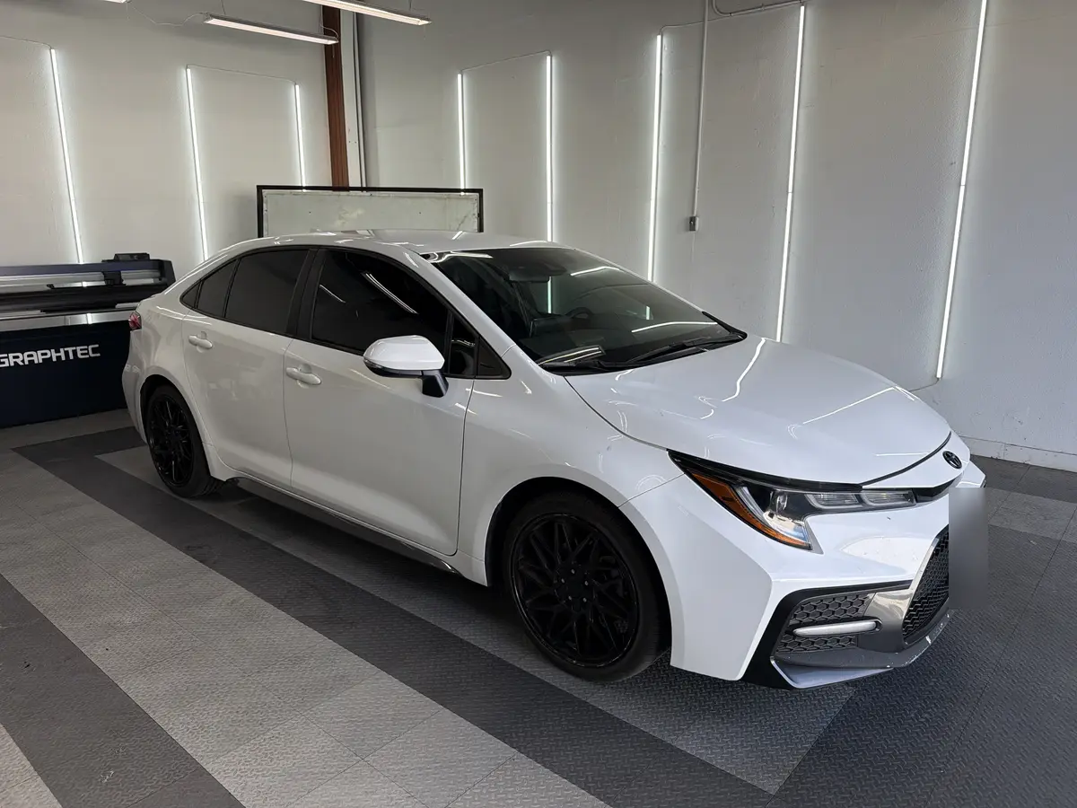 White Toyota Corolla after Avery Dennison Encore carbon window tint (view 1)