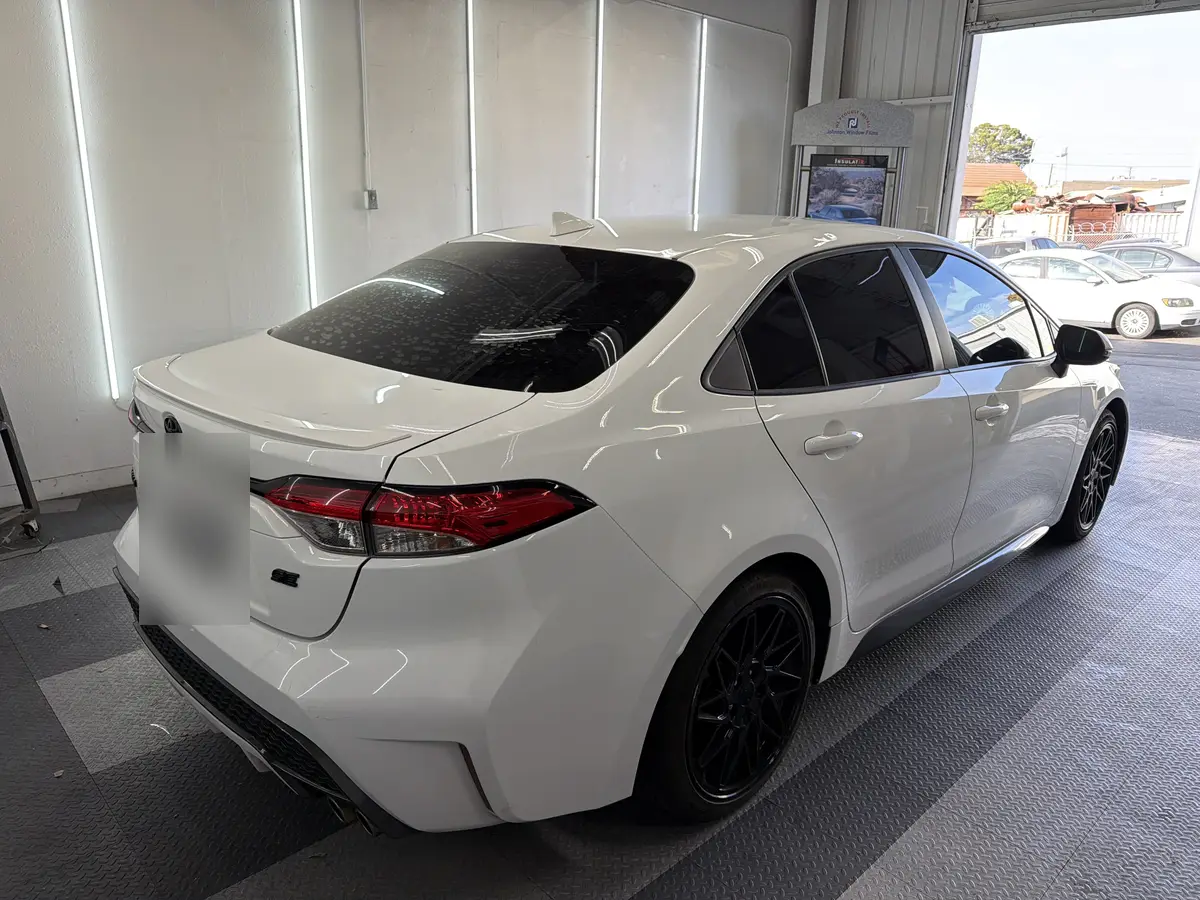 White Toyota Corolla after Avery Dennison Encore carbon window tint (view 3)