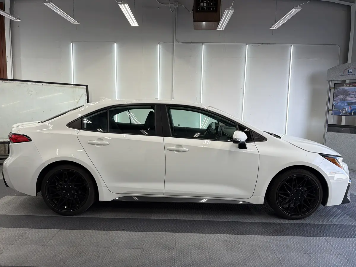 White Toyota Corolla before window tinting, factory glass (view 2)