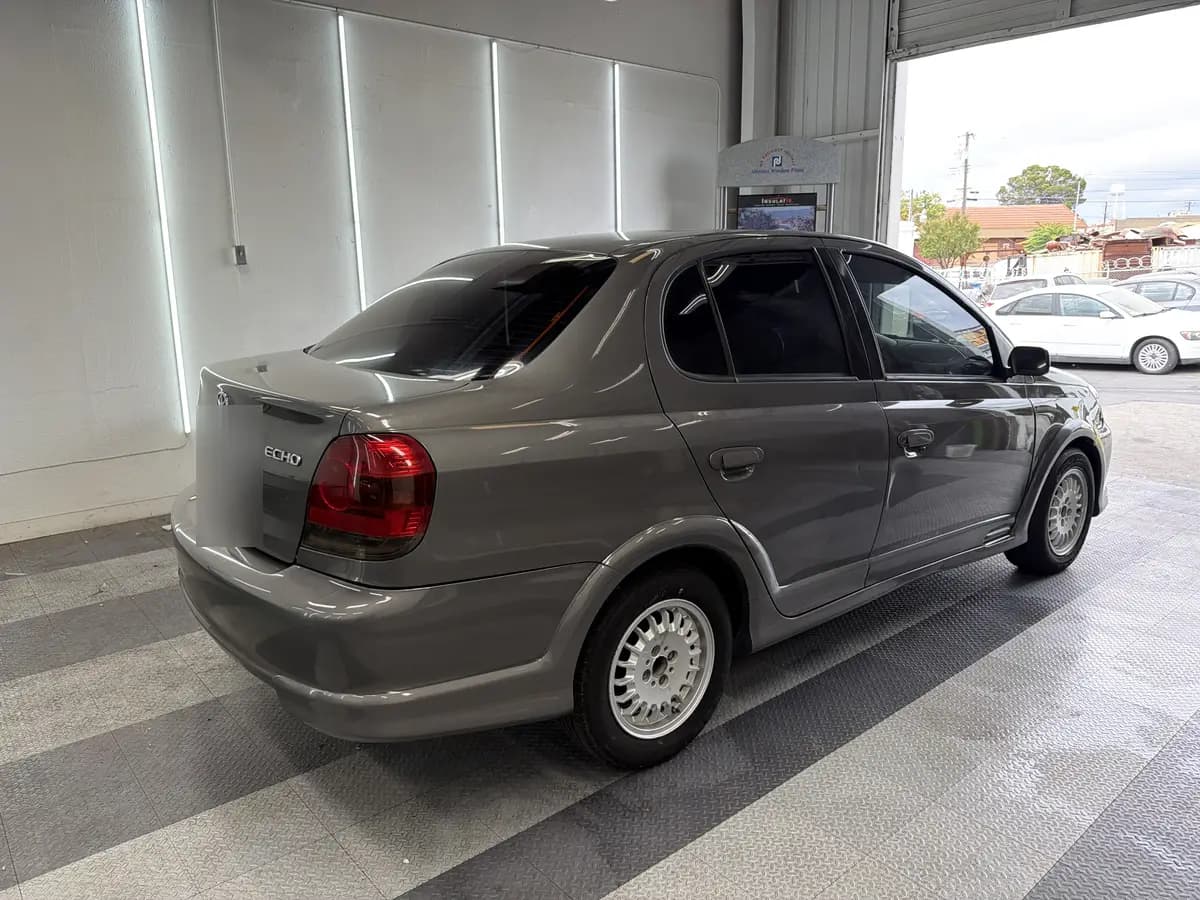 Gray Toyota Echo after Avery Dennison Encore carbon window tint (view 1)