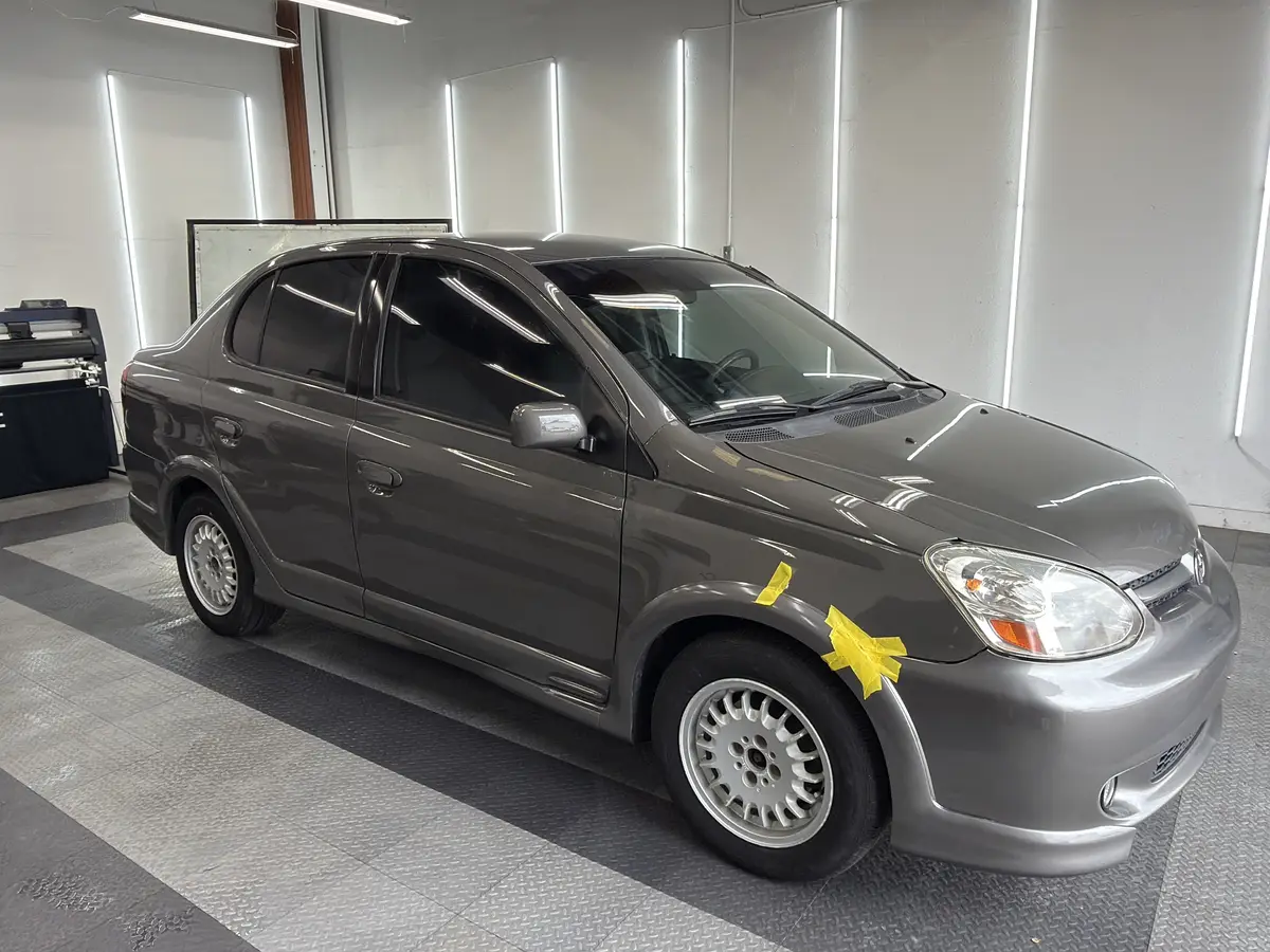 Gray Toyota Echo after Avery Dennison Encore carbon window tint (view 3)