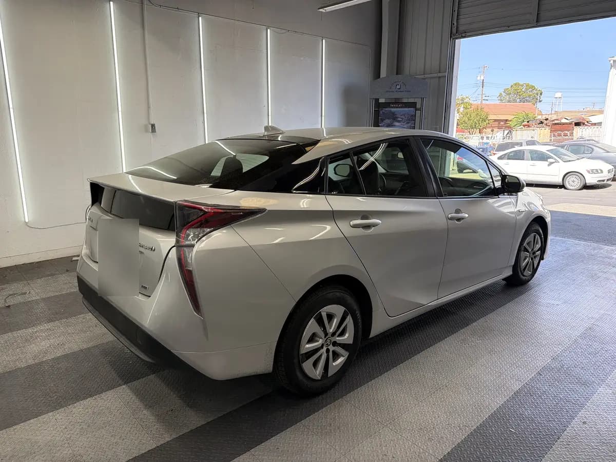 Silver Toyota Prius before window tinting, factory glass (view 3)