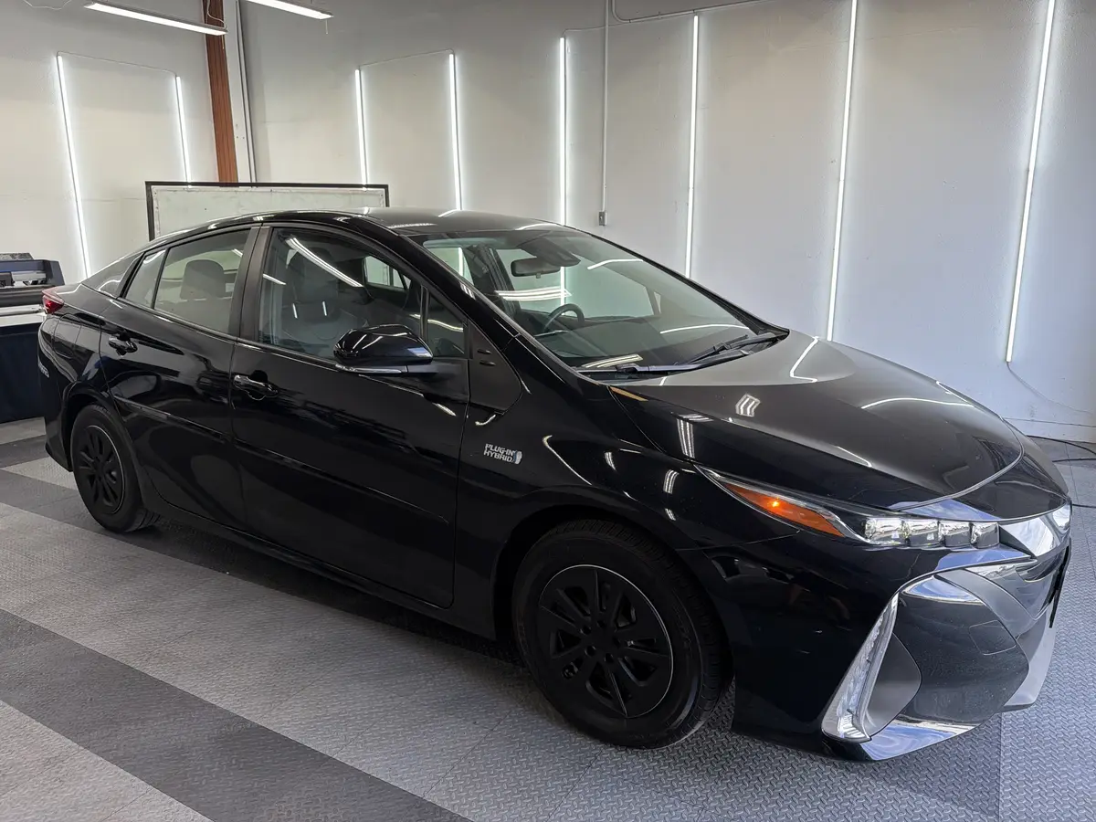 Black Toyota Prius Prime before window tinting, factory glass (view 1)