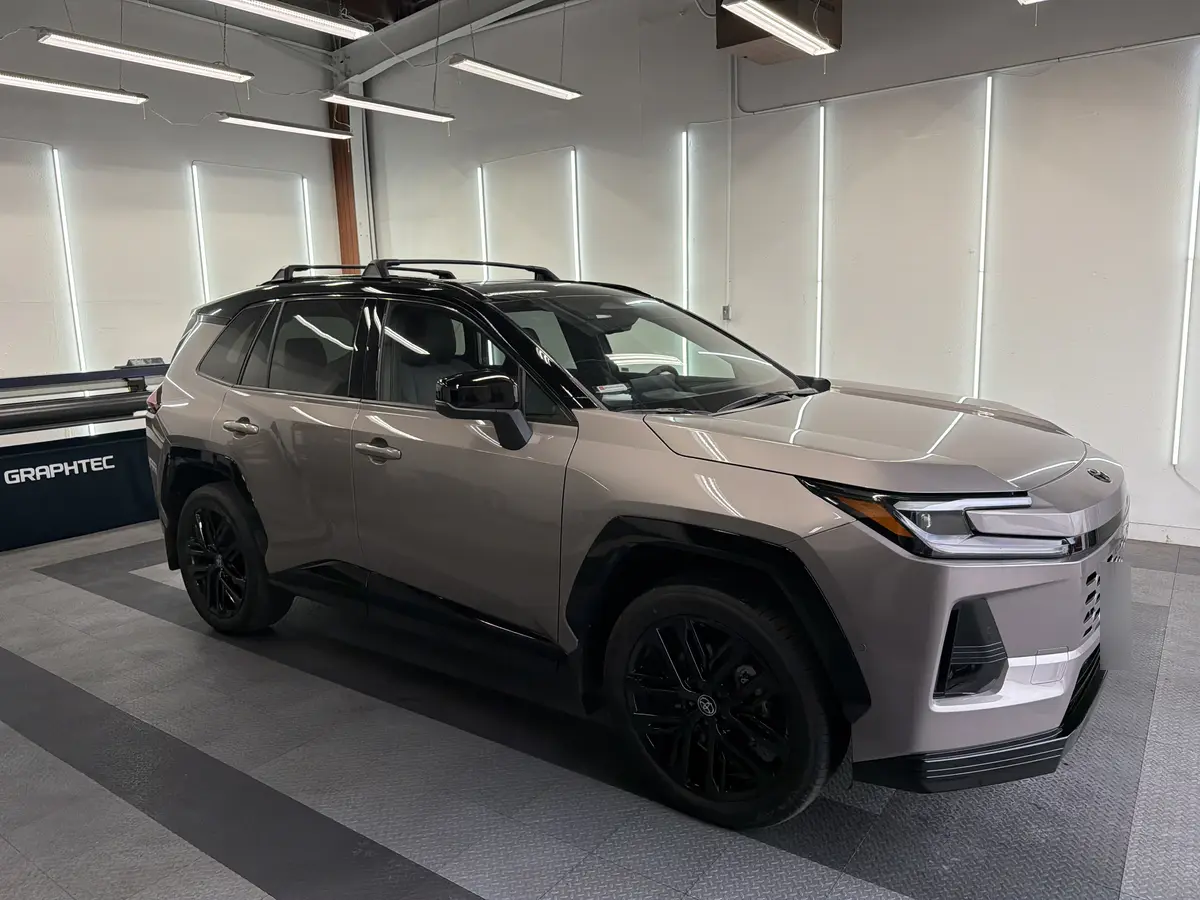 Gray Toyota RAV4 before window tinting, factory glass (view 1)