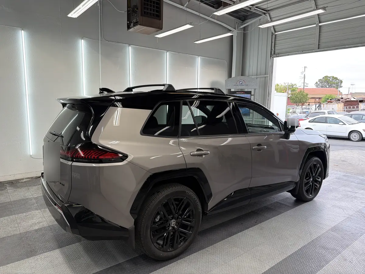 Gray Toyota RAV4 before window tinting, factory glass (view 3)