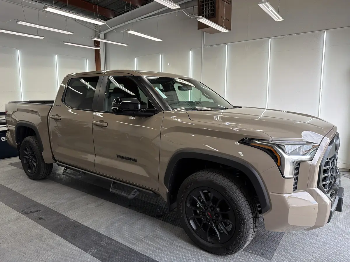Tan Toyota Tundra before window tinting, factory glass (view 1)