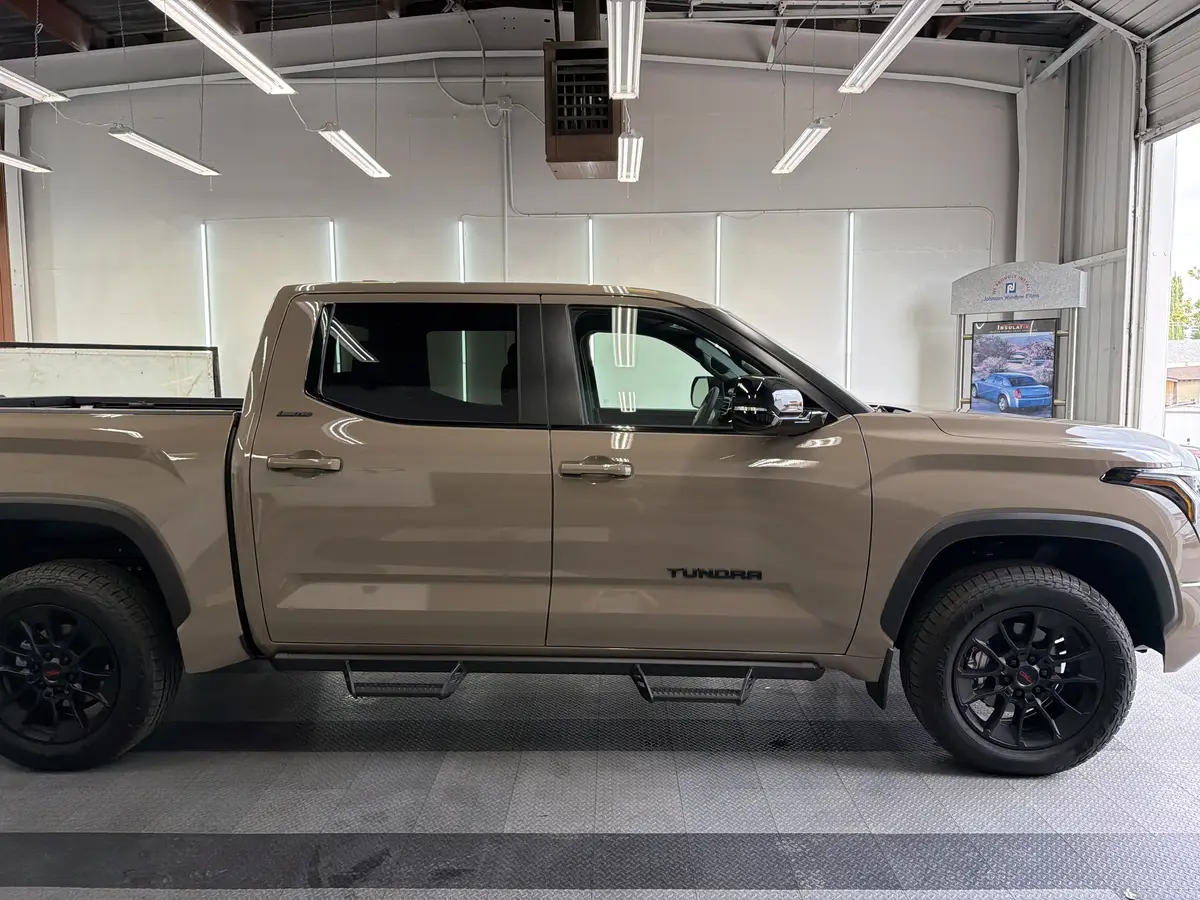 Tan Toyota Tundra before window tinting, factory glass (view 2)