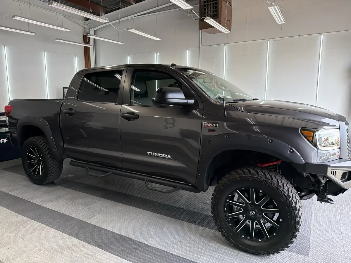Gray Toyota Tundra before window tinting, factory glass (view 1)
