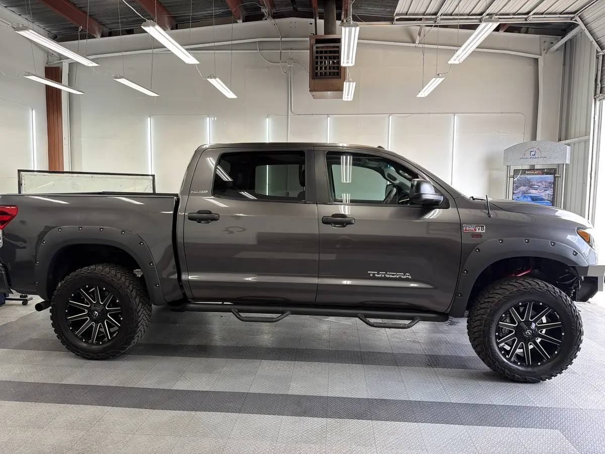 Gray Toyota Tundra before window tinting, factory glass (view 2)