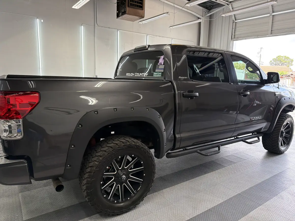 Gray Toyota Tundra before window tinting, factory glass (view 3)