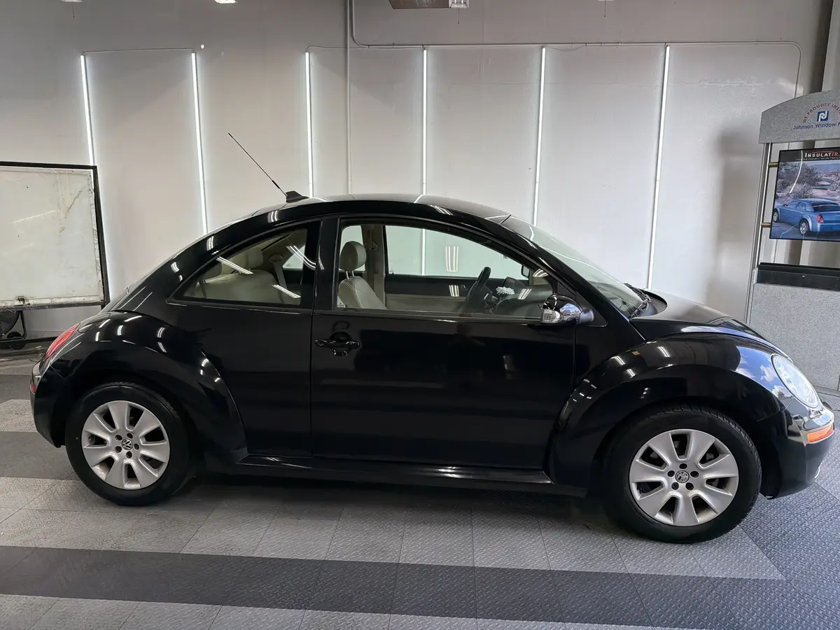 Black Volkswagen Beetle before window tinting, factory glass (view 2)