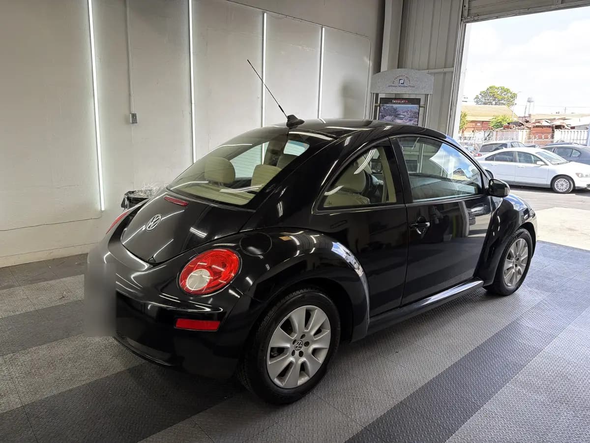 Black Volkswagen Beetle before window tinting, factory glass (view 3)