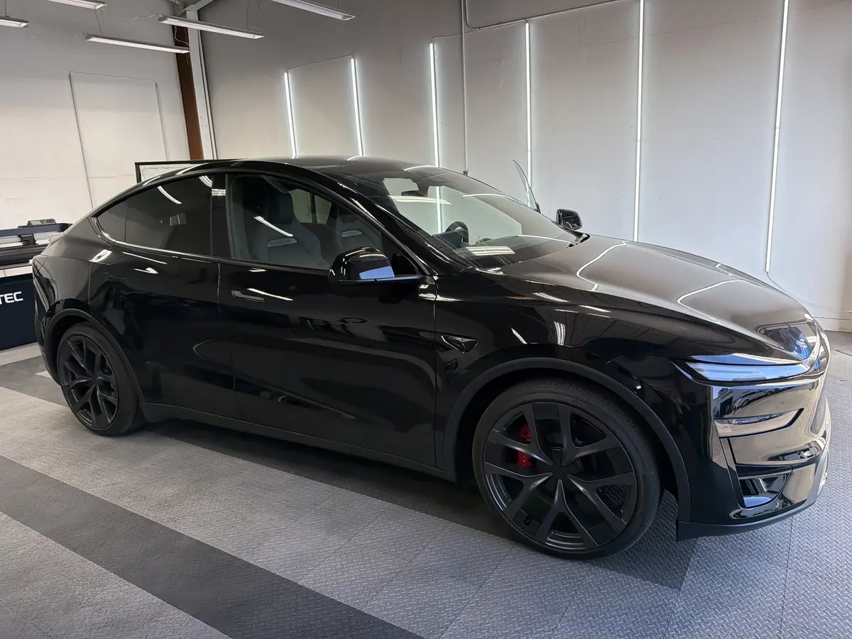 Black Tesla Model Y before window tinting, factory glass (view 1)