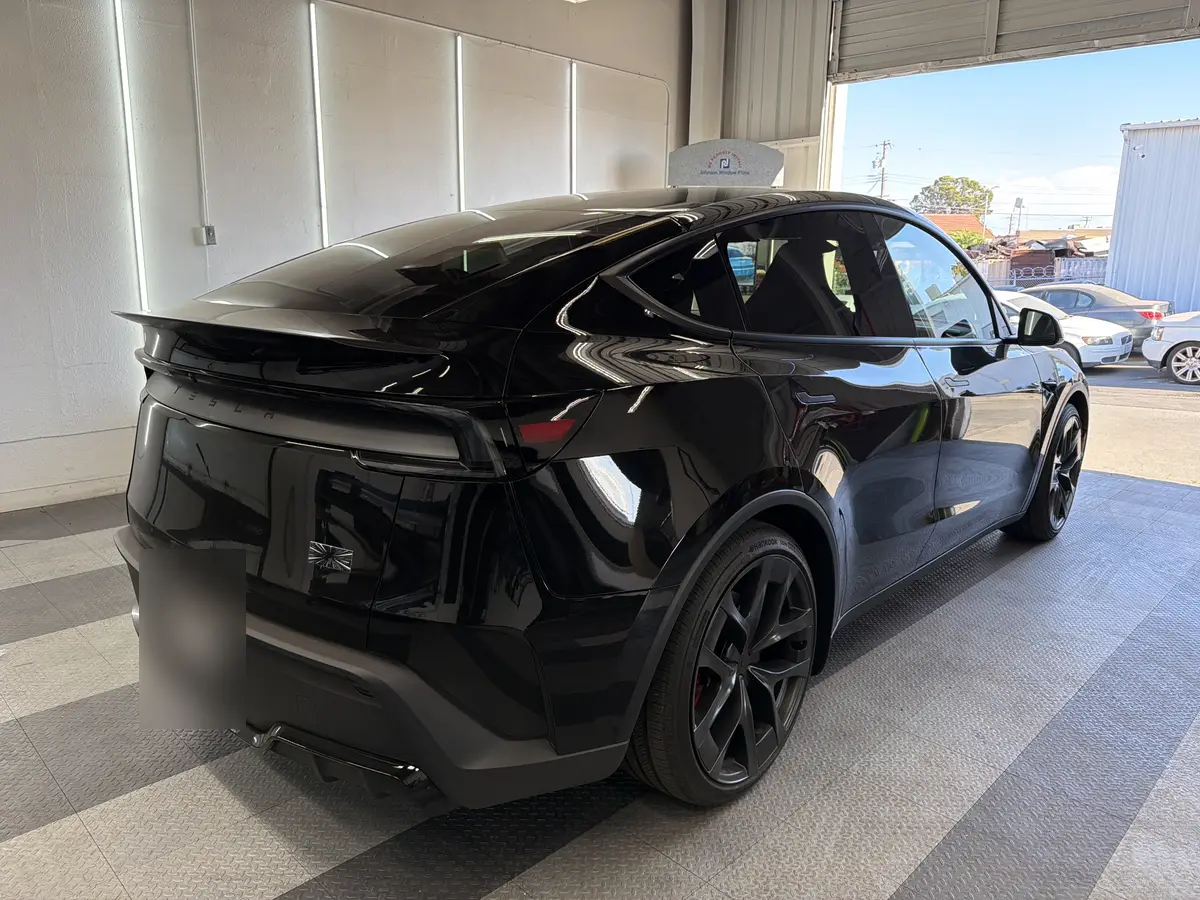 Black Tesla Model Y before window tinting, factory glass (view 3)
