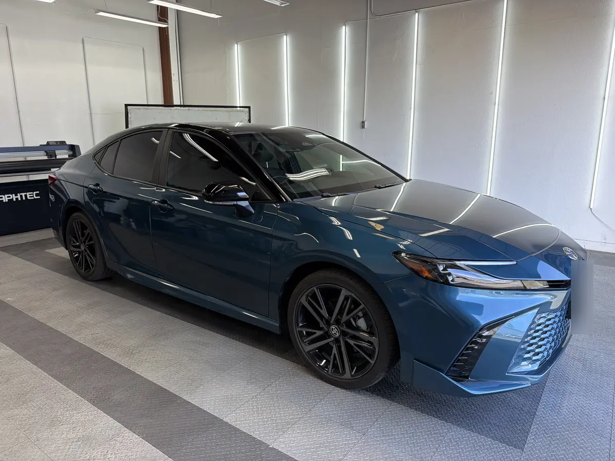 Blue Toyota Camry before window tinting, factory glass (view 1)