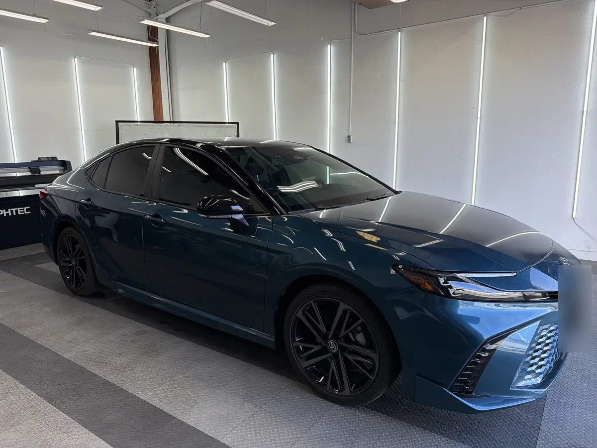 Blue Toyota Camry before window tinting, factory glass (view 2)