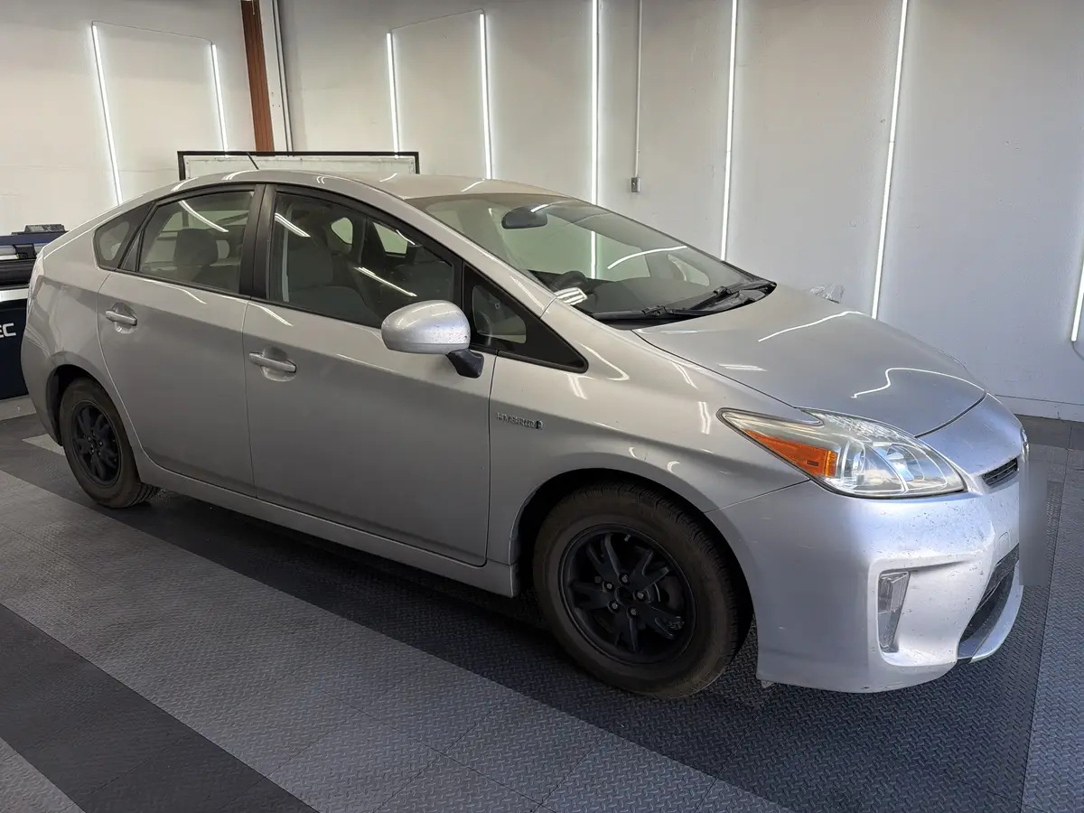 Silver Toyota Prius before window tinting, factory glass (view 1)
