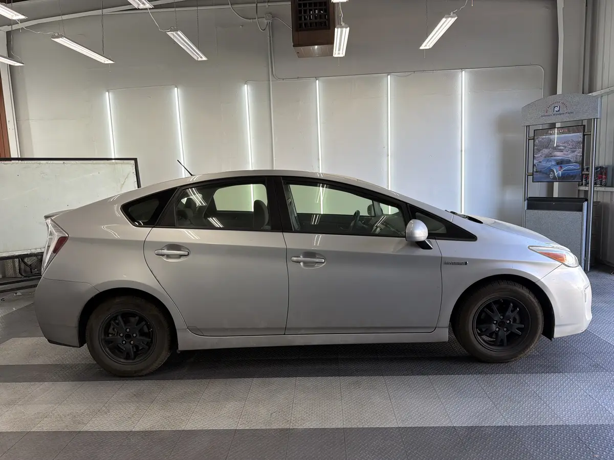 Silver Toyota Prius before window tinting, factory glass (view 2)