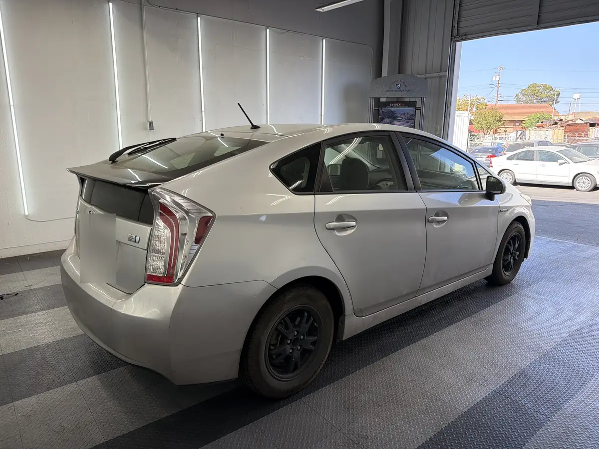 Silver Toyota Prius before window tinting, factory glass (view 3)
